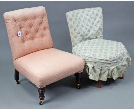 An early 20th century buttoned-back nursing chair on turned legs with ceramic castors; together with another nursing chair.