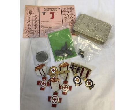 A small collection of military related items. To include British Red Cross medals, lucky bullet in button, reproduction Princ
