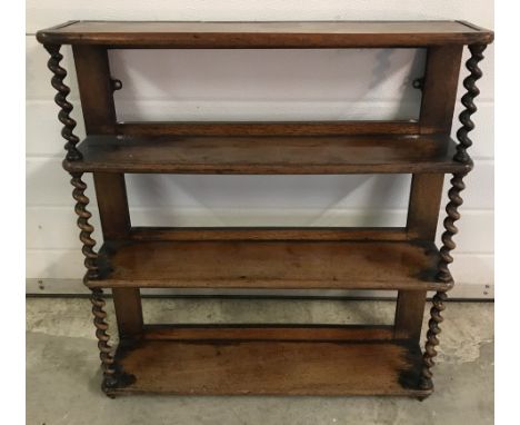 An Antique dark wood wall hanging shelf with barley twist columns.  Approx. 66cm wide x 70cm tall.