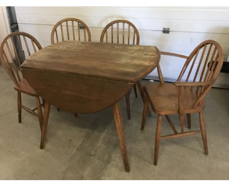 An Ercol oval drop leaf table and 4 chairs. 3 plus 1 carver 103 x 116cm when open