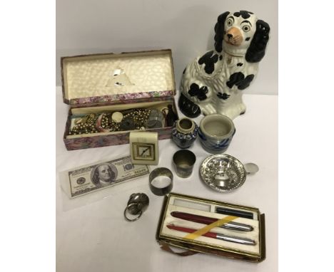 A  small collection of mixed items. To include costume jewellery, cigarette cards, A Staffordshire dog a/f and a Westclox tra