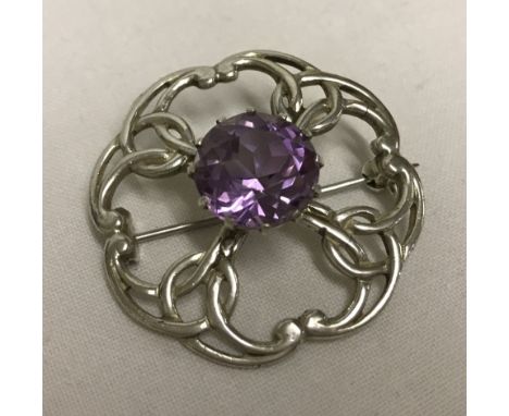 A scottish Silver brooch set with a late central amethyst. Hallmarked Edinburgh 1991. 
