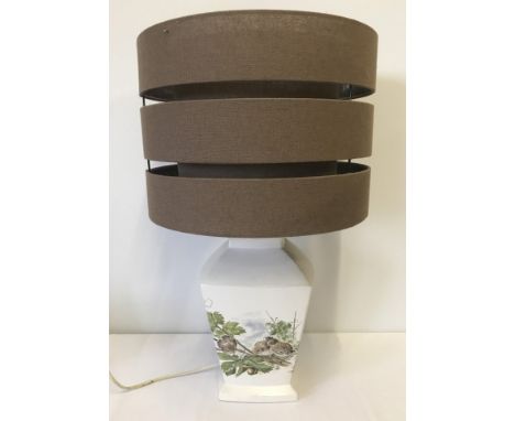 A ceramic table lamp with bird & insect decoration. Brown circular double shade. 