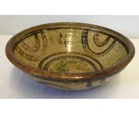 A large Winchcombe Pottery bowl by Michael Cardew dated between 1926 - 1939. In brown and beige. Some chips to rim. Approx. 3