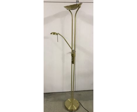 A modern brushed brass effect standard lamp with adjustable reading light.  