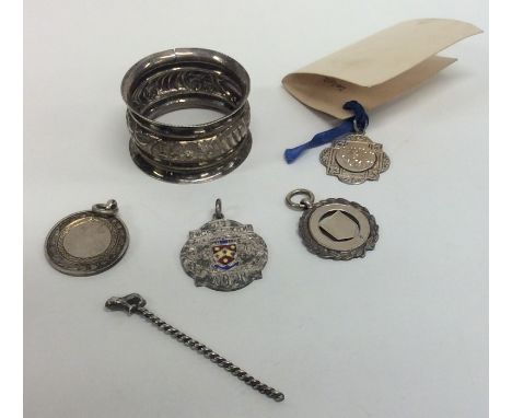 A small silver watch medallion, napkin ring etc. Approx. 43 grams. Est. £20 - £30.