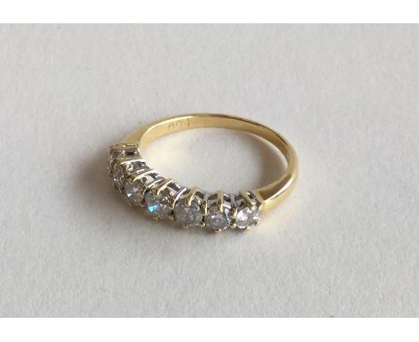 A good 18 carat diamond seven stone half hoop ring in claw mount. Approx. 3.2 grams. Est. £100 - £150.