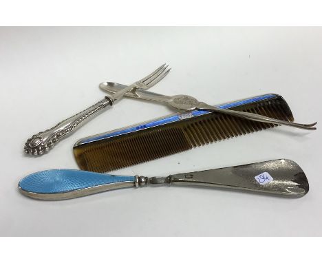 A silver and enamelled comb together with a lobster pick etc. Approx. 200 grams. Est. £25 - £35.