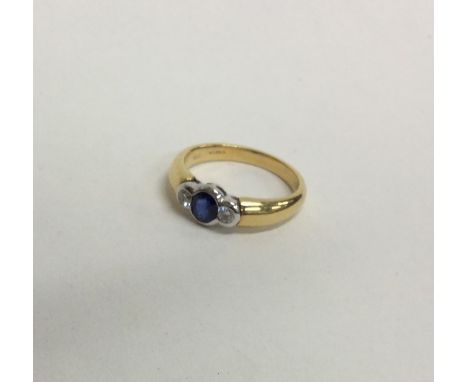 A heavy sapphire and diamond three stone gypsy set ring in 18 carat and platinum. Approx. 5 grams. Est. £120 - £150.