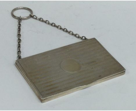 An engine turned silver card case on suspension chain. Birmingham. By LE. Approx. 41 grams. Est. £20 - £30.