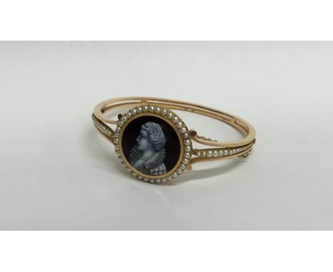 An unusual gold hinged bangle inset with enamelled miniature in pearl frame and concealed clasp. Approx. 24 grams. Est. £700 