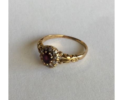 An attractive ruby and diamond cluster ring in 18 carat claw mount. Approx. 3.4 grams. Est. £80 - £120.