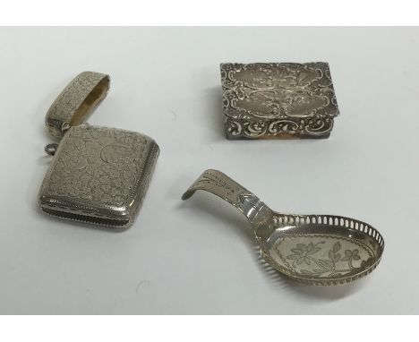 A Georgian silver bright cut caddy spoon together with a vesta case etc. Approx. 66 grams. Est. £30 - £40.