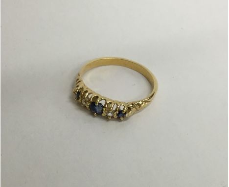 A sapphire and diamond five stone ring in claw mount. Approx. 3.5 grams. Est. £80 - £120.