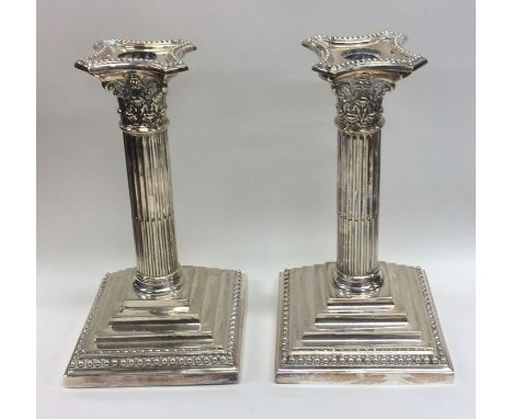 A good pair of Corinthian column candlesticks with step bases. Est. £50 - £80.