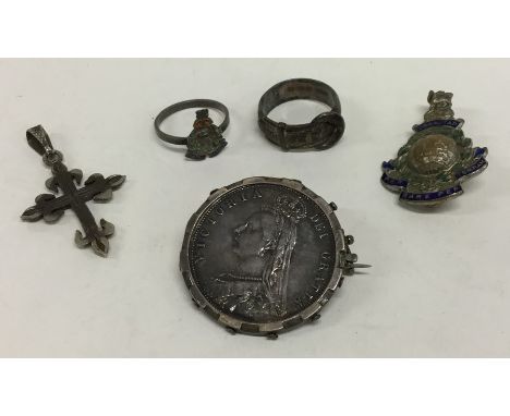 A silver buckle ring together with an enamel brooch etc. Approx. 34 grams. Est. £20 - £30.