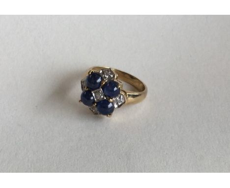 A cabochon sapphire and diamond cluster ring in 9 carat mount. Approx. 4.6 grams. Est. £40 - £60.