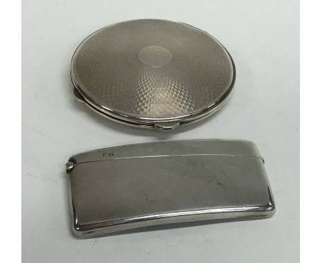A heavy silver engine turned compact together with a card case. Approx. 146 grams. Est. £20 - £30.