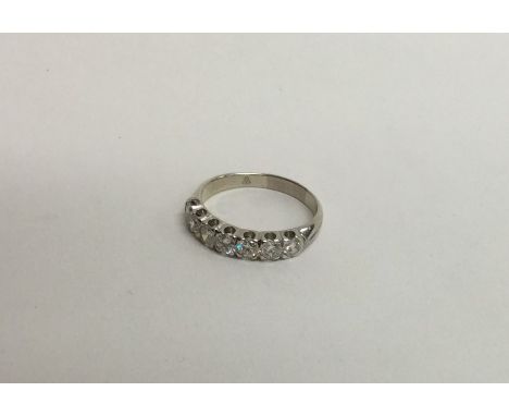 A good quality 18 carat white gold seven stone ring with rubover mount. Approx. 3.5 grams. Est. £150 - £200.