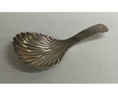 A Georgian silver bright cut caddy spoon with fluted bowl. Approx. 7 grams. Est. £40 - £60.