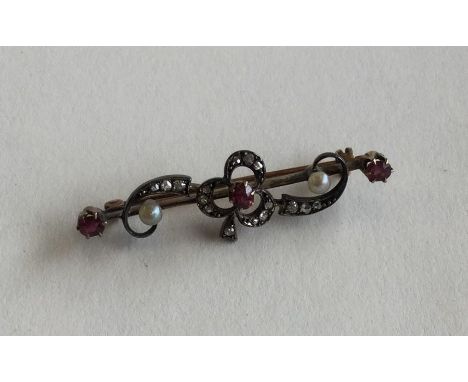 A mid-Victorian rose diamond and ruby brooch in claw mount and two colour gold. Approx. 4.2 grams. Est. £150 - £200.