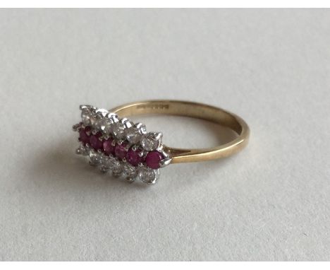 A ruby and diamond triple row ring in 9 carat setting. Approx. 2.7 grams. Est. £80 - £120.