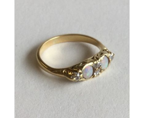 An opal and diamond six stone ring in 18 carat gold. Approx. 3.1 grams. Est. £50 - £80.