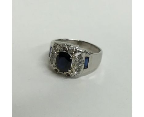 A large sapphire and diamond cluster ring in 18 carat white gold. Approx. 15.3 grams. Est. £300 - £400.