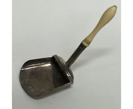 An unusual Georgian silver caddy scoop with turned ivory handle. Approx. 5 grams. Est. £40 - £60.