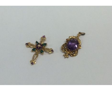 An amethyst and gold pendant together with one other. Approx. 8.2 grams. Est. £60 - £80.
