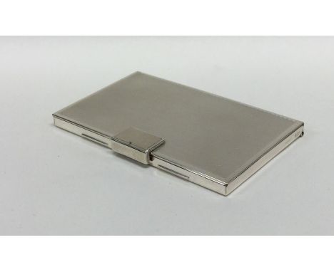 A heavy silver engine turned card case with hinged top. Approx. 74 grams. Est. £30 - £50.