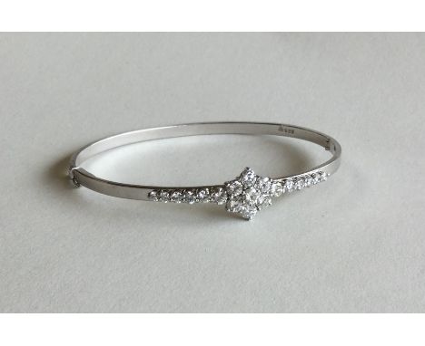A good diamond and gold bangle mounted as a cluster with tapering shoulders and claw mount with concealed clasp. Approx. 23 g