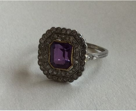 A good amethyst and diamond cluster ring with cut corners and platinum mount. Approx. 5.3 grams. Est. £600 - £800.