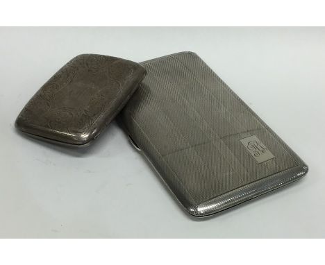 A heavy engine turned silver cigarette box together with one other. Approx. 263 grams. Est. £40 - £60.