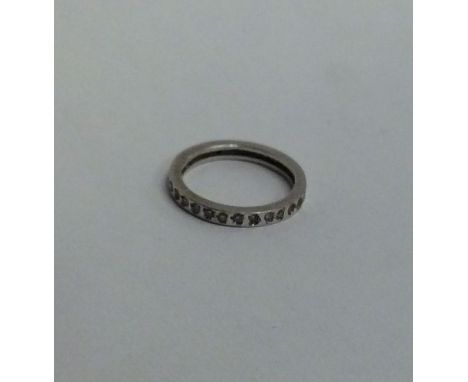 A white gold and diamond full eternity ring. Ring size 'L'. Approx. 2.6 grams. Est. £100 - £150.