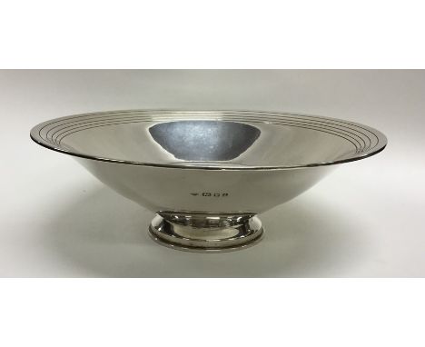 A heavy tapering silver fruit bowl with engine turned decoration. London. By WS. Approx. 553 grams. Est. £150 - £250.