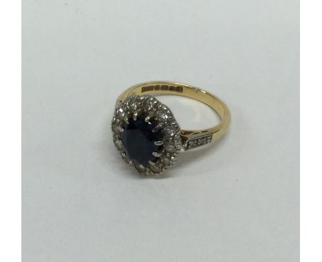 A good 18 carat sapphire and diamond cluster ring in claw mount. Approx. 5.2 grams. Est. £200 - £300.