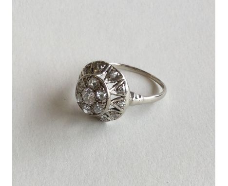A good diamond circular cluster ring with pierced mount. Approx. 3.6 grams. Est. £100 - £150.