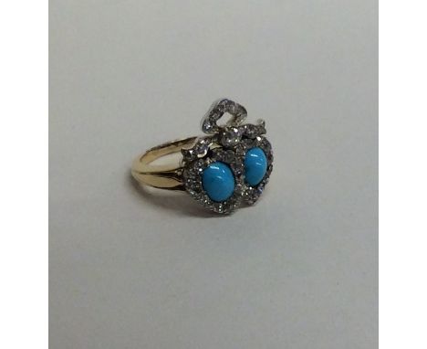 An unusual Victorian turquoise and diamond double heart ring in 18 carat setting. Approx. 5.3 grams. Est. £400 - £600.
