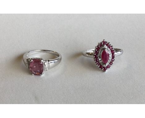 A ruby and diamond marquise shaped 9 carat cluster ring together with one other. Approx. 6.8 grams. Est. £60 - £80.