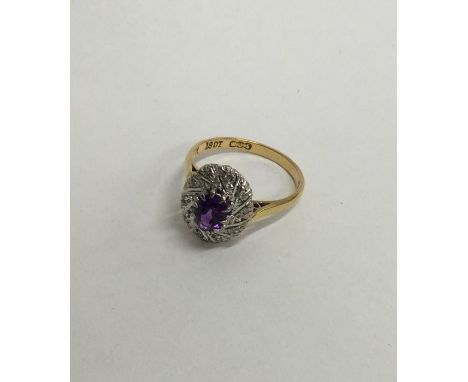 An amethyst and diamond 18 carat cluster ring. Approx. 4.4 grams. Est. £60 - £80.