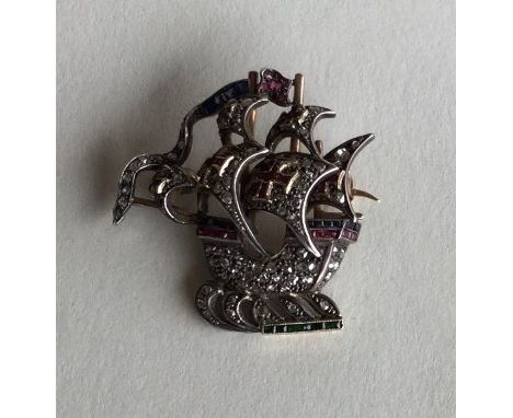 A novelty diamond set brooch in the form of a galleon with emerald, sapphire and ruby mounts. Approx. 9.7 grams. Est. £400 - 