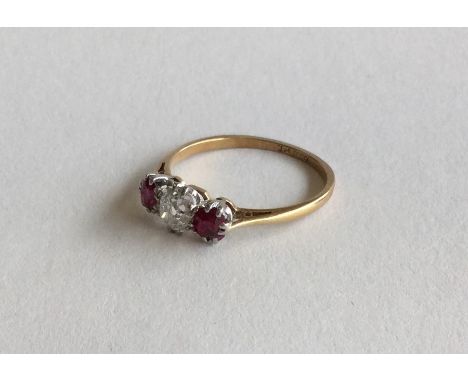 An old cut diamond and ruby three stone ring in 18 carat and platinum mount. Approx. 2.2 grams. Est. £100 - £150.