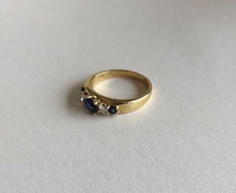 A lady's 18 carat sapphire and diamond five stone ring in claw mount. Approx. 3.5 grams. Est. £50 - £80.