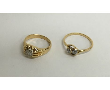 A gent's 18 carat single stone gypsy set ring together with a crossover ring. Approx. 7.5 grams. Est. £150 - £200.
