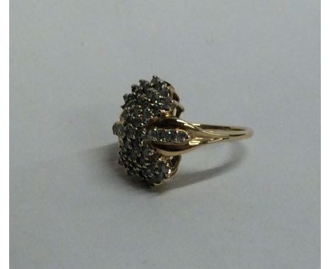 A large 14 carat gold diamond cluster ring in claw mount. Approx. 6.3 grams. Est. £80 - £120.