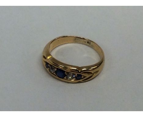 A sapphire and diamond five stone gypsy set ring in 18 carat. Approx. 5.2 grams. Est. £80 - £120.