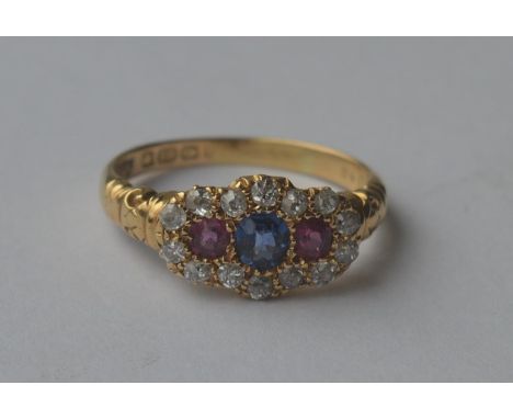 A Victorian ruby, sapphire and diamond cluster ring in 18 carat claw mount. Approx. 4.8 grams. Est. £800 - £1000.