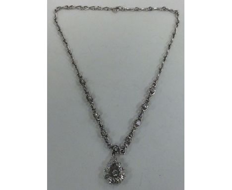 A good heavy 18 carat white gold diamond necklace with tear shaped drop and ring clasp. Approx. 26 grams. Est. £1500 - £2000.