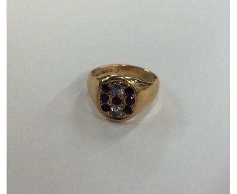 An 18 carat gold gent's signet ring inset with rubies and diamonds. Approx. 15 grams. Est. £350 - £450.